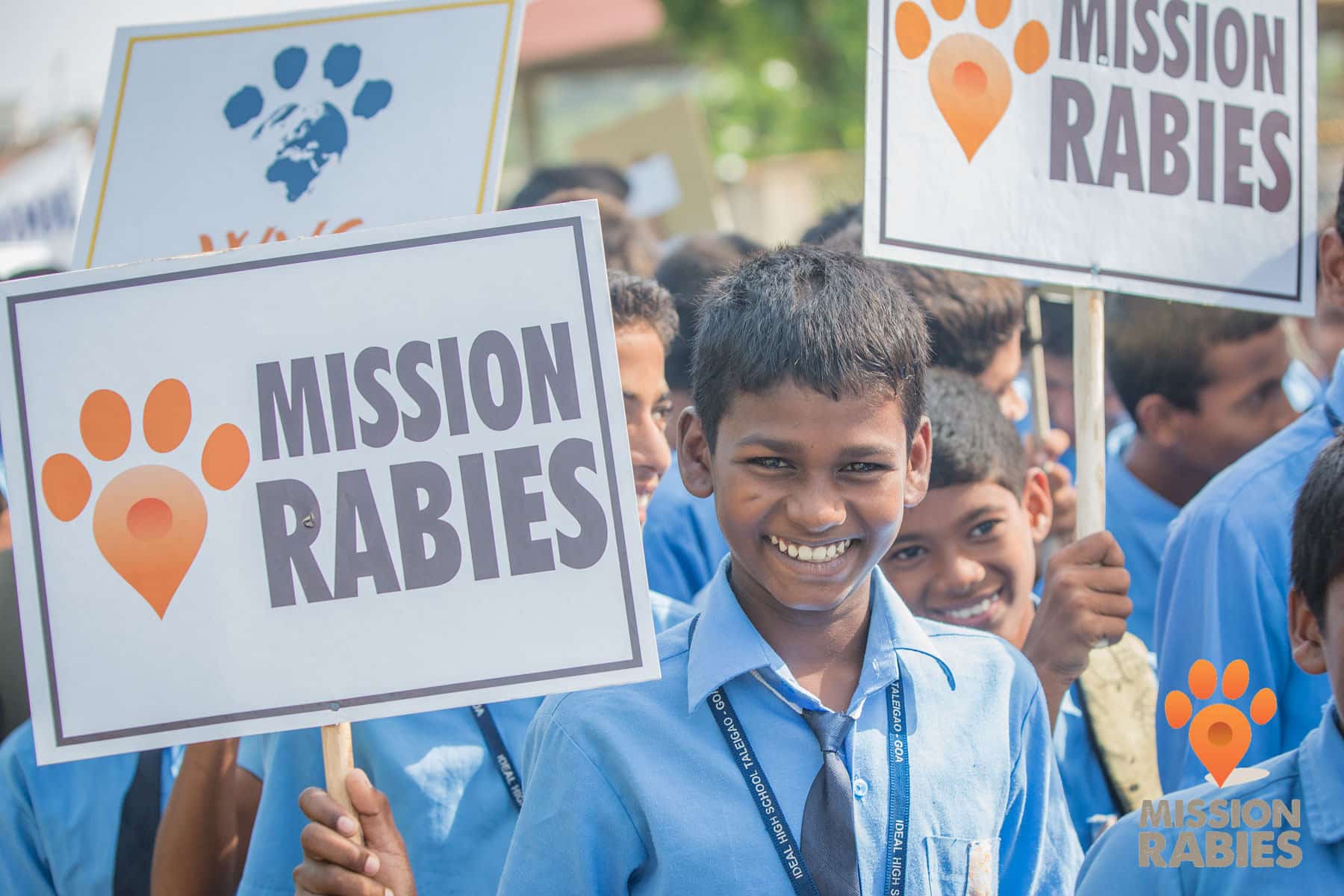 Child holding Mission Rabies placard
